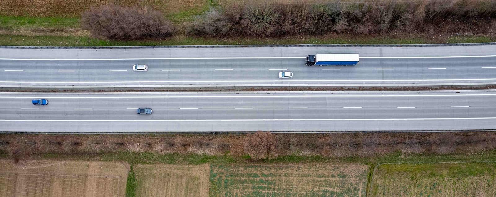 Aerial view of a delivery truck and cars on a highway